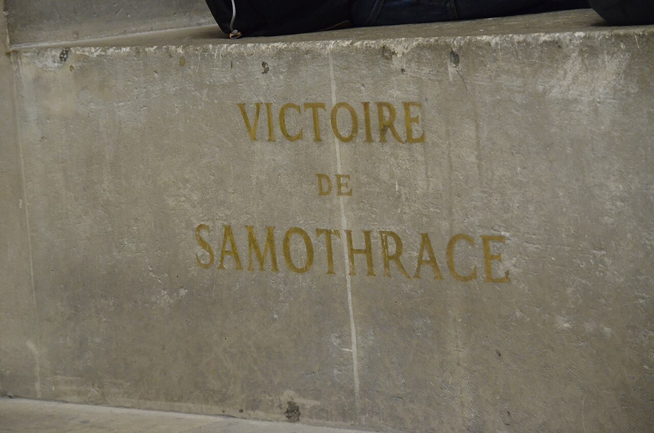 The Winged Victory of Samothrace standing at the top of the Daru staircase in the Louvre Museum